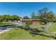 Cozy single-story home with brown siding and a spacious front yard, secured by a chain-link fence at 1505 Ne 33Rd Pl, Ocala, FL 34479