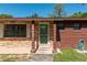 Inviting front door with brick accents and a cozy porch area, showcasing the home's curb appeal at 1505 Ne 33Rd Pl, Ocala, FL 34479