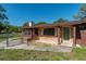 Brick-accented front entrance with a well-manicured lawn and a secure fence at 1505 Ne 33Rd Pl, Ocala, FL 34479