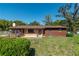 Inviting single-story home featuring a mix of brick and wood exterior with lush front yard at 1505 Ne 33Rd Pl, Ocala, FL 34479