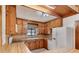 Kitchen features wood cabinets, tile floor, and white appliances at 1505 Ne 33Rd Pl, Ocala, FL 34479