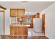 A bright kitchen features wood cabinetry, a tile floor, and a breakfast bar, adding warmth and functionality to the space at 1505 Ne 33Rd Pl, Ocala, FL 34479