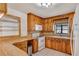 Kitchen features wood cabinets, tile floor, and white appliances at 1505 Ne 33Rd Pl, Ocala, FL 34479