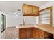 Kitchen with breakfast bar, wood cabinets, and white appliances at 1505 Ne 33Rd Pl, Ocala, FL 34479