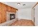 Living room features wood floors and a brick fireplace with wood mantel at 1505 Ne 33Rd Pl, Ocala, FL 34479