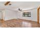 The bright living room features hardwood floors and natural light from a large window and a white front door at 1505 Ne 33Rd Pl, Ocala, FL 34479