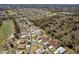 Panoramic aerial showcasing a neighborhood with tree-lined streets, manicured lawns, and a golf course in the distance at 15304 Sw 15Th Terrace Rd, Ocala, FL 34473
