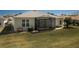 Back exterior shot of the home shows the backyard and screened in porch at 15304 Sw 15Th Terrace Rd, Ocala, FL 34473