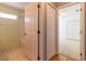 Hallway view into the bathroom with shower/tub, tile floor and closet at 15304 Sw 15Th Terrace Rd, Ocala, FL 34473