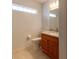 Bathroom features a granite vanity top, wood cabinets, and an open-window above the toilet at 15304 Sw 15Th Terrace Rd, Ocala, FL 34473