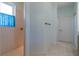 Bright tiled bathroom with white walls, window, and a walk-in shower at 15304 Sw 15Th Terrace Rd, Ocala, FL 34473