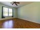 This bedroom features hardwood floors, natural light, and a ceiling fan at 15304 Sw 15Th Terrace Rd, Ocala, FL 34473