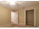 This bedroom has carpet flooring, a ceiling fan, and closet for storage at 15304 Sw 15Th Terrace Rd, Ocala, FL 34473
