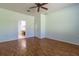 This bedroom features hardwood floors, natural light, and an ensuite bathroom at 15304 Sw 15Th Terrace Rd, Ocala, FL 34473