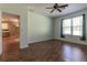 Spacious bedroom with hardwood floors, fan, and natural light with views of the kitchen at 15304 Sw 15Th Terrace Rd, Ocala, FL 34473