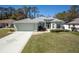 Charming single-story home with a well-manicured lawn, lovely landscaping, and a spacious two-car garage at 15304 Sw 15Th Terrace Rd, Ocala, FL 34473