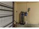 Garage interior view showcasing a water filtration system and grey roll-up door at 15304 Sw 15Th Terrace Rd, Ocala, FL 34473