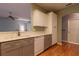 Bright kitchen features gray and white cabinets, modern appliances, and beautiful hardwood flooring at 15304 Sw 15Th Terrace Rd, Ocala, FL 34473