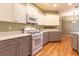 Updated kitchen featuring white appliances, and gray lower cabinets at 15304 Sw 15Th Terrace Rd, Ocala, FL 34473