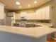 This kitchen features white cabinets, granite counters, and stainless appliances at 15304 Sw 15Th Terrace Rd, Ocala, FL 34473