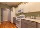 Well-equipped kitchen with gas range, white cabinets, and gray lower cabinets at 15304 Sw 15Th Terrace Rd, Ocala, FL 34473