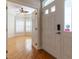 Bright living room showcasing hardwood floors and ample sunlight streaming through the windows and doorway at 15304 Sw 15Th Terrace Rd, Ocala, FL 34473