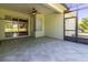 Enclosed lanai with ceiling fan and sliding door access to the home's interior at 15304 Sw 15Th Terrace Rd, Ocala, FL 34473