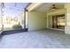 Screened-in patio with a ceiling fan and backyard view of the landscaping at 15304 Sw 15Th Terrace Rd, Ocala, FL 34473
