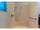 Bathroom with a tiled walk-in shower, safety bar, and seat at 15304 Sw 15Th Terrace Rd, Ocala, FL 34473