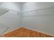 Empty walk-in closet with wooden floor, white walls, and wire shelving at 15304 Sw 15Th Terrace Rd, Ocala, FL 34473