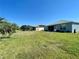 Beautiful backyard with lush lawn, palm trees, and a screened-in porch for relaxation at 15702 Sw 16Th Avenue Rd, Ocala, FL 34473
