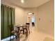 Cozy dining area with tiled floors, a glass table, and views into the hallway and nearby bedroom at 15702 Sw 16Th Avenue Rd, Ocala, FL 34473