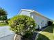 Home exterior featuring a well-manicured landscape with lovely green bushes at 15702 Sw 16Th Avenue Rd, Ocala, FL 34473