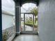 View from front porch through decorative storm door of the landscaped yard at 15702 Sw 16Th Avenue Rd, Ocala, FL 34473