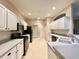 Well-lit kitchen with stainless steel appliances, ample counter space, and convenient access to the adjacent dining area at 15702 Sw 16Th Avenue Rd, Ocala, FL 34473