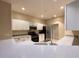 Bright kitchen features white cabinetry, stainless steel appliances, and ample counter space for meal preparation at 15702 Sw 16Th Avenue Rd, Ocala, FL 34473