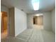 Spacious carpeted living room with neutral walls and an archway to another room at 15702 Sw 16Th Avenue Rd, Ocala, FL 34473