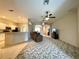 Spacious open-concept living room featuring ceiling fans, comfortable seating, and views of the kitchen and entryway at 15702 Sw 16Th Avenue Rd, Ocala, FL 34473