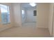 Bright living room featuring neutral walls, plush carpeting, and ample natural light from a window at 15702 Sw 16Th Avenue Rd, Ocala, FL 34473