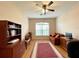 Well-lit office featuring a ceiling fan, wooden desk and bookshelf, with a cozy sofa for a relaxing atmosphere at 15702 Sw 16Th Avenue Rd, Ocala, FL 34473