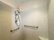 This shower is equipped with grab bars and an adjustable shower head at 15702 Sw 16Th Avenue Rd, Ocala, FL 34473