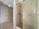Tiled stand up shower with glass door in a neutral colored bathroom at 1732 Se 38Th Ct, Ocala, FL 34471