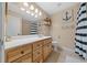 Light and airy bathroom features a wooden vanity, nautical decor, and tiled floor at 1732 Se 38Th Ct, Ocala, FL 34471