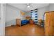 Bright bedroom featuring wood floors, a wooden bed frame, and natural light at 1732 Se 38Th Ct, Ocala, FL 34471