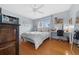 Bright bedroom with hardwood floors, a ceiling fan, and built-in shelves at 1732 Se 38Th Ct, Ocala, FL 34471