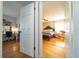 View from hallway to bedroom featuring hardwood floors, a ceiling fan, and large bed at 1732 Se 38Th Ct, Ocala, FL 34471