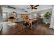 Spacious open-concept living and dining area featuring a large wooden table and modern decor at 1732 Se 38Th Ct, Ocala, FL 34471