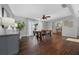 Modern dining room showcasing wood floors, a sleek table, and a view to the entryway at 1732 Se 38Th Ct, Ocala, FL 34471
