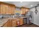The well-appointed kitchen features granite countertops, stainless steel appliances, and wood cabinets at 1732 Se 38Th Ct, Ocala, FL 34471