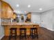 Kitchen boasts wooden cabinetry, granite countertops, a breakfast bar with seating, and hardwood floors at 1732 Se 38Th Ct, Ocala, FL 34471